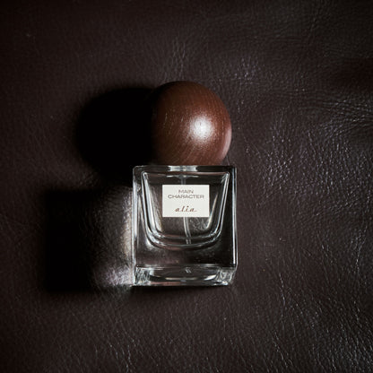 Alia Main Character perfume on black leather background